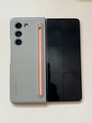 two cell phones sitting next to each other on top of a table