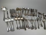 a lot of spoons and forks on the table
