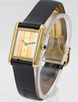 an image of a gold and black wrist watch with a black band