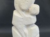 an image of a white stone sculpture of a woman holding a child