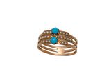 un gros plan d'une bague ornée d'une pierre turquoise et de perles