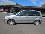 a small silver car parked in a parking lot