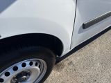 a close up of a white car parked on the side of the road