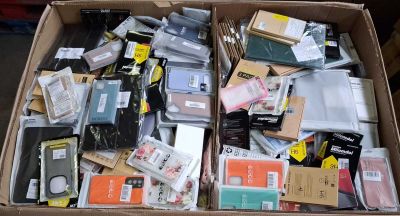 a cardboard box full of electronic devices and other items