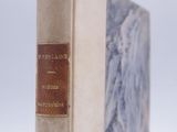 an old book sitting on top of a white table