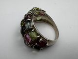 a close up of a ring with multi colored stones on it
