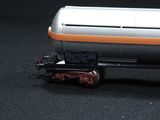 a silver and orange train car on a black surface