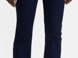 the woman is wearing a white shirt and blue jeans