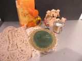 a lot of doily on a table with a candle and a plate
