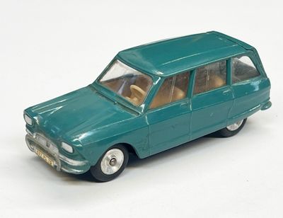 une petite voiture verte posée sur une surface blanche