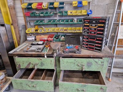 a workbench with two drawers full of tools