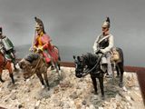 three figurines of men riding horses on display