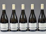 six bouteilles de vin sont alignées sur une table