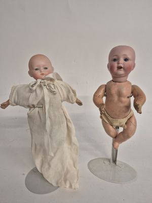two dolls that are standing next to each other