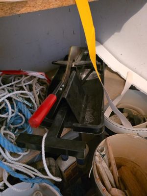 a bucket of clutter and a pair of scissors on a shelf
