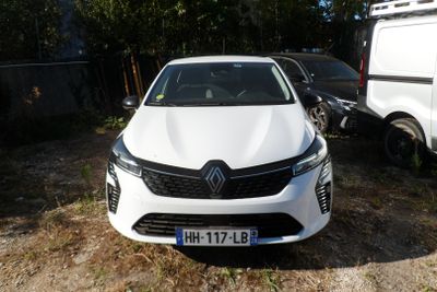 a white car that is parked next to a white van