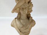 marble bust of a woman with a hat and a bird on her head