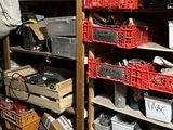 many baskets and bins on the shelves in the garage