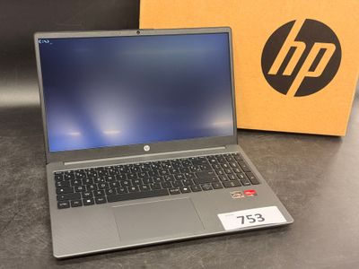 a laptop computer sitting on top of a table next to a box