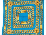 a blue and gold scarf with a chain link design