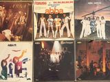 many different album covers on the table