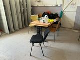 a room with a table, chairs, and a refrigerator in it