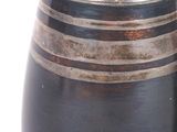 a black vase with a striped design on it