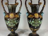 pair of antique vases with floral designs on them on a white surface