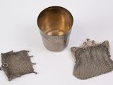 a silver cup with a chain around it next to a silver cup with a chain around it next to a silver cup with a chain around it