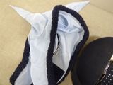 a black hat and a blue shirt on a couch