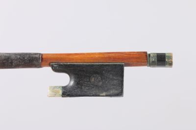 a violin bow with a wooden handle on a white surface