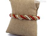 a pillow with a pillow and a bracelet on it