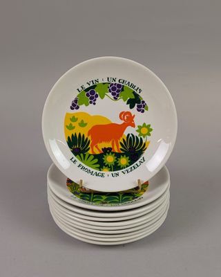 four plates with a deer design on them stacked on top of each other