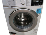 an image of a washing machine with a button on the front