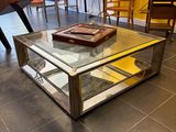 a coffee table with a glass top in the middle of a room