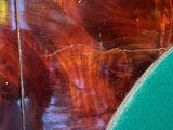 a close up of a surfboard on a wooden table