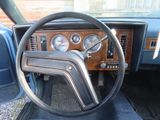 a steering wheel and gauges in the dashboard of a car