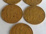 four gold coins with a picture of a man and a woman on them