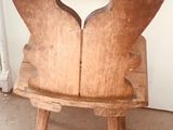 a wooden chair with a heart cut out of it