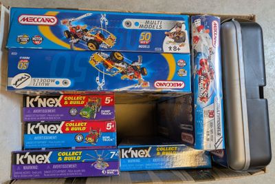 several boxes of toys are stacked on top of each other on the floor