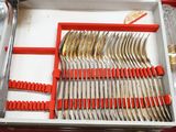a red box with silverware in it on a table