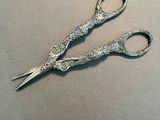 a pair of scissors that are sitting on top of a table