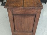 a small wooden cabinet that is sitting on the floor