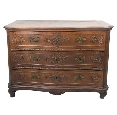 a wooden chest of drawers with ornate carvings on the drawers