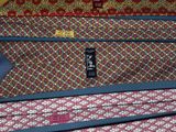 several ties are stacked on top of each other on a blue surface