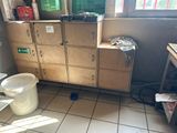 a trash can and a bucket in the corner of a room