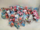 a pile of pink and blue candies in a white box
