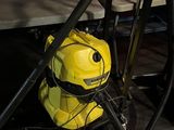 a yellow vacuum cleaner sitting on the floor next to a table