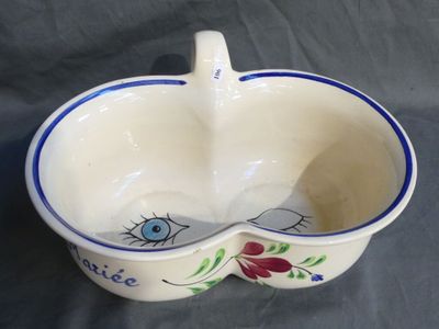 a white bowl with a blue and red design on it
