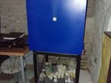 une image représentant une armoire bleue contenant tout un tas d'objets